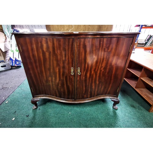 486 - Serpentine solid mahogany cabinet stamped W. Fowkes on top of the doors