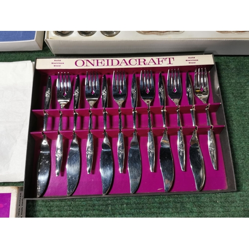 14 - Two cased cutlery sets  one by oneida along with a complete fruit and ice cream 12 person set