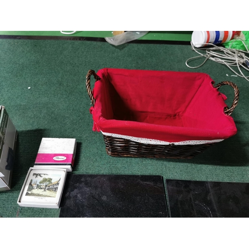 21 - Boxed cast iron kettle, wicker basket, quantity of table mats etc