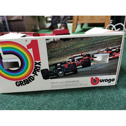 25 - Boxed burago grand prix formula one car along with a large plastic shell tanker lorry