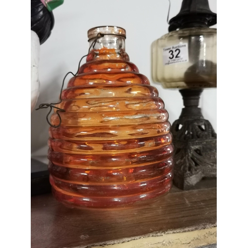 32 - Two antique oil lamps and a orange glass fly catcher