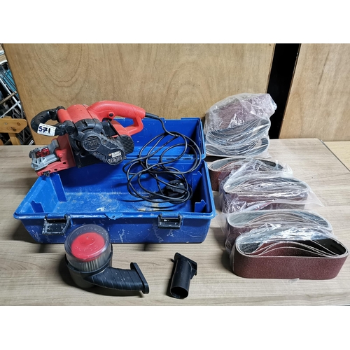 571 - Black and decker belt sander along with a large quantity of unused sanding belts in plastic tool che... 