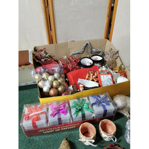 36 - Two boxes full of Christmas decorations including a gold glitter reindeer, baubles, tree decorations... 