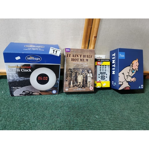 11 - Quantity of various items inc alarm clock, tintin boxset and a six in one remote controller