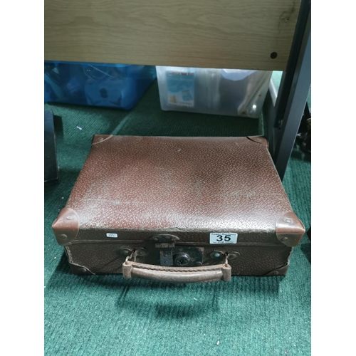 35 - Collection of china in a leather suitcase inc Bell's whisky jug