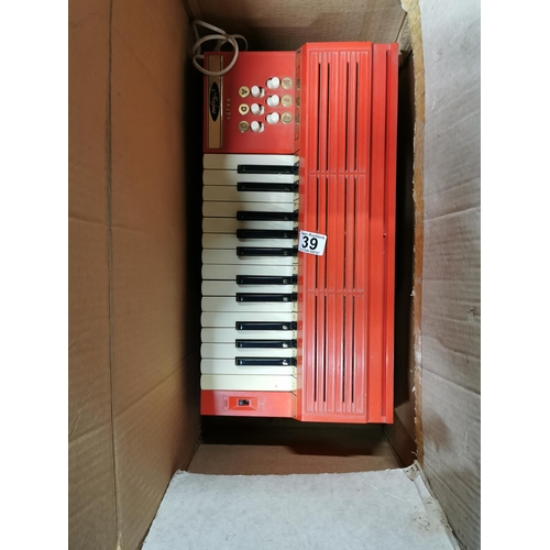 39 - Magnus electric organ in original box with removable legs along with music books and along with anot... 