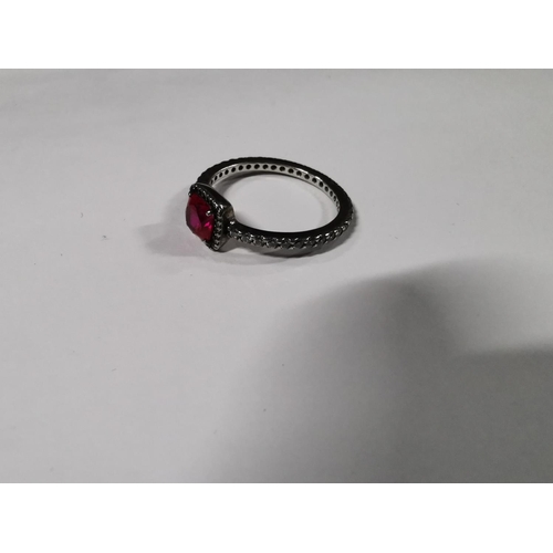 53 - Genuine Pandora ring inset with a large red stone and a quantity of clear stones all the way round t... 