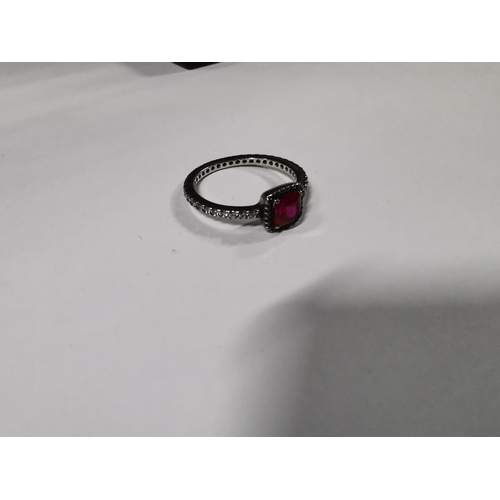 53 - Genuine Pandora ring inset with a large red stone and a quantity of clear stones all the way round t... 