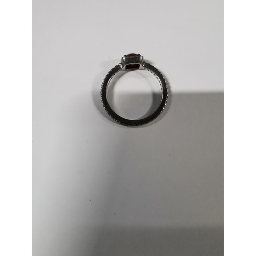 53 - Genuine Pandora ring inset with a large red stone and a quantity of clear stones all the way round t... 