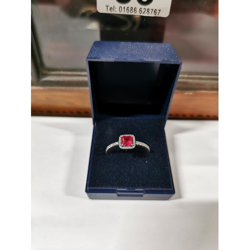 53 - Genuine Pandora ring inset with a large red stone and a quantity of clear stones all the way round t... 