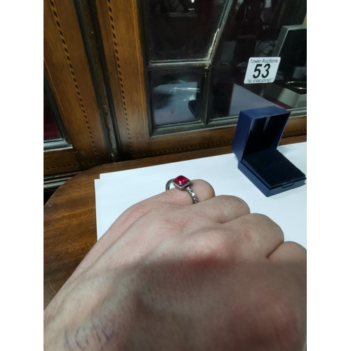 53 - Genuine Pandora ring inset with a large red stone and a quantity of clear stones all the way round t... 