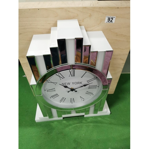 92 - New York Inspired Mirrored & White Glass Tabletop Quartz Clock, has a small chip as shown on photos.... 