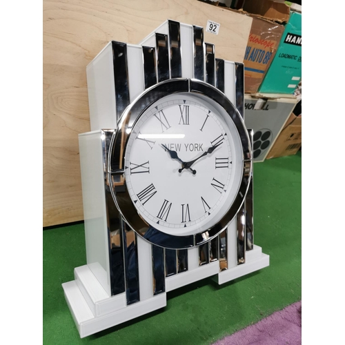 92 - New York Inspired Mirrored & White Glass Tabletop Quartz Clock, has a small chip as shown on photos.... 