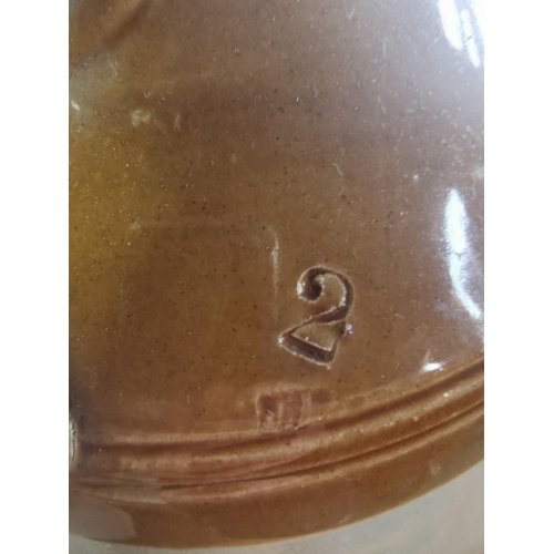 395 - Large stoneware flaggon marked tro to the base with a broad arrow military mark 1944 along with a st... 