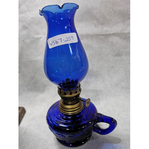 157 - Cast iron oil lamp with glass font with a smaller blue glass oil lamp