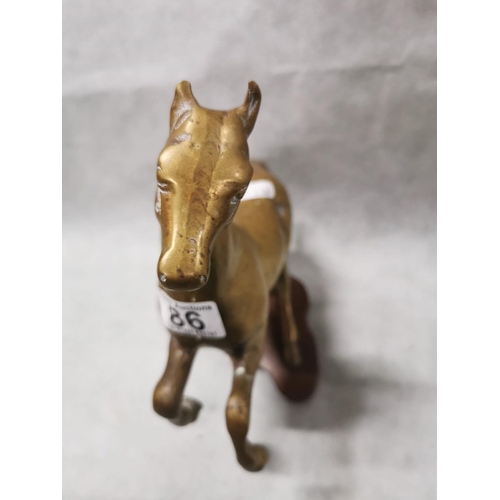 86 - Pair of vintage solid brass horses on plinths one rearing one cantering, total weight of 7.6kg