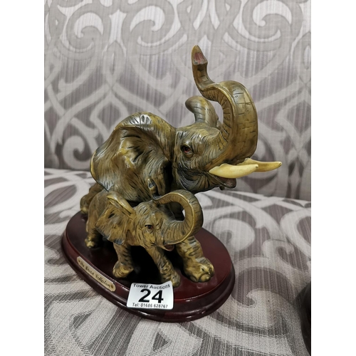 24 - 4 elephants, two resin, two ebony carved book ends. The book ends have old repairs, good detailing