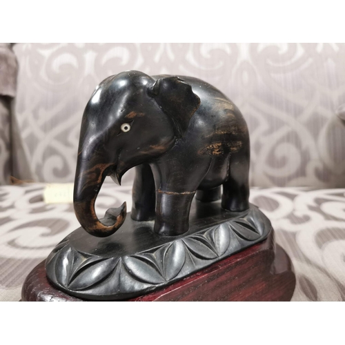 24 - 4 elephants, two resin, two ebony carved book ends. The book ends have old repairs, good detailing