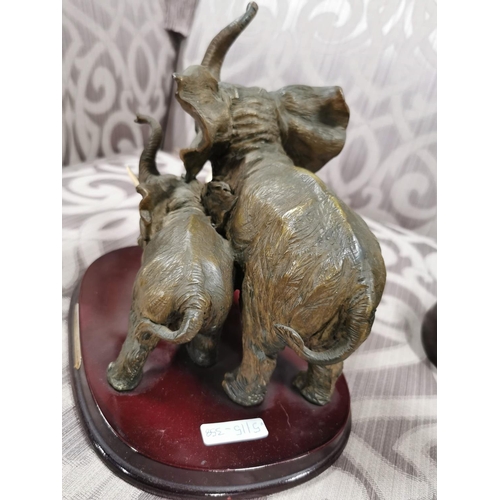 24 - 4 elephants, two resin, two ebony carved book ends. The book ends have old repairs, good detailing