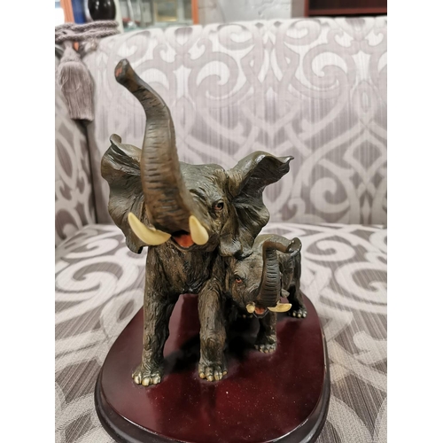 24 - 4 elephants, two resin, two ebony carved book ends. The book ends have old repairs, good detailing