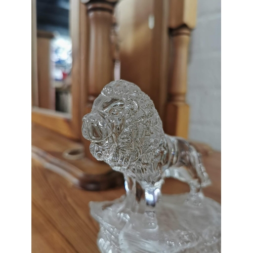 25 - one resin bronze colour lion and one crystal glass lion on plinths. Height of largest item is 23cm x... 