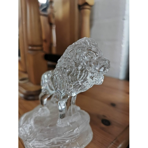 25 - one resin bronze colour lion and one crystal glass lion on plinths. Height of largest item is 23cm x... 