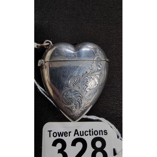 328 - Hm silver heart formed vesta case with an etched design and a striker to the side is hallmarked for ... 