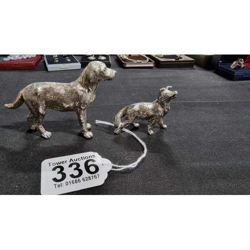 336 - 2 well modelled white metal dog figures in good condition the larger 6.5cm high length 10 cm ,smalle... 