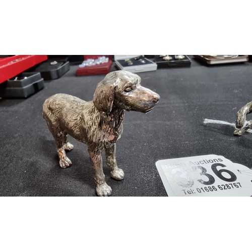 336 - 2 well modelled white metal dog figures in good condition the larger 6.5cm high length 10 cm ,smalle... 