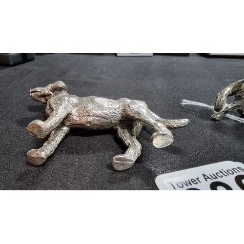 336 - 2 well modelled white metal dog figures in good condition the larger 6.5cm high length 10 cm ,smalle... 