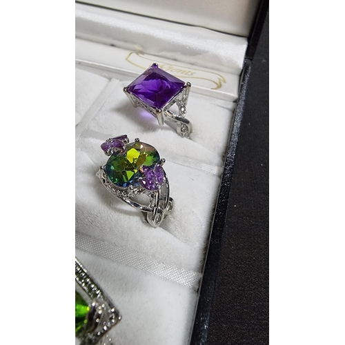 344 - Cased set of 12 ornate silver plated dress rings various large coloured stones various sizes L to W ... 