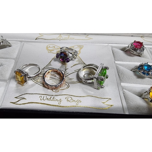 344 - Cased set of 12 ornate silver plated dress rings various large coloured stones various sizes L to W ... 