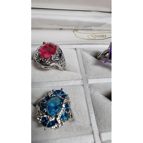 344 - Cased set of 12 ornate silver plated dress rings various large coloured stones various sizes L to W ... 