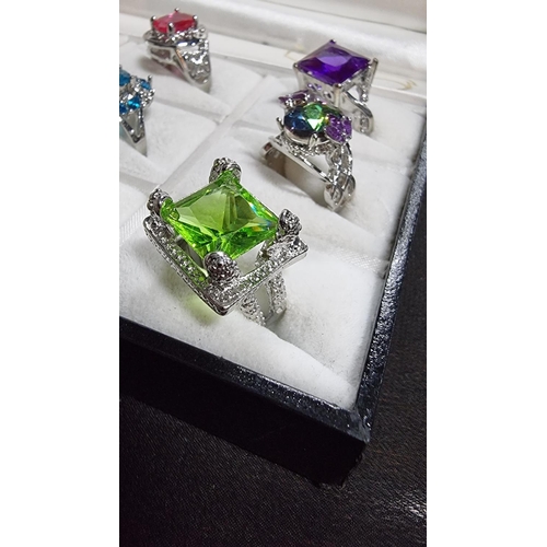 344 - Cased set of 12 ornate silver plated dress rings various large coloured stones various sizes L to W ... 