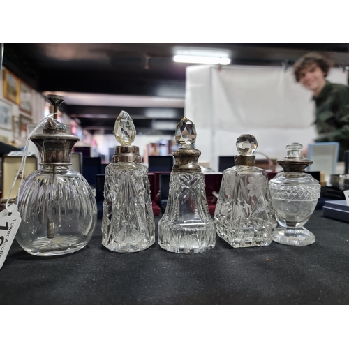 187 - Quantity of 4 scent bottles with hallmarked silver collars and a silver topped atomizer