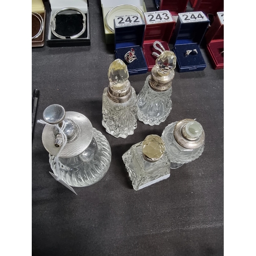 187 - Quantity of 4 scent bottles with hallmarked silver collars and a silver topped atomizer