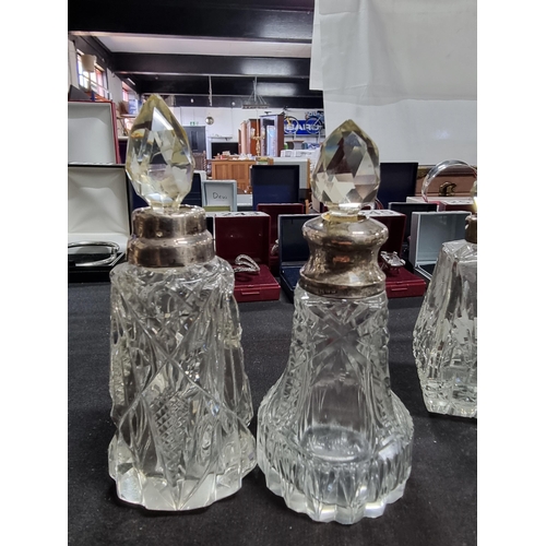 187 - Quantity of 4 scent bottles with hallmarked silver collars and a silver topped atomizer