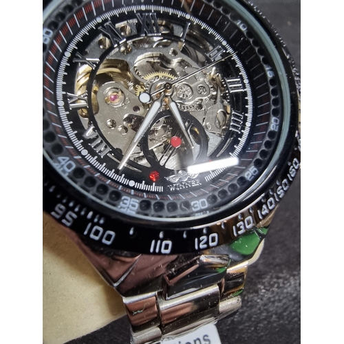 208 - New ex display silvertone gents wrist watch by Winner featuring a skeleton dial still has the wrappi... 