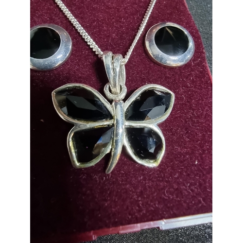 218 - 925 silver butterfly pendant with black crystal stones set on a long 20in silver chain along with a ... 