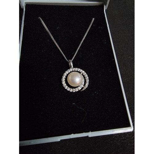 223 - 925 silver pendant inset with a genuine pearl and a large quantity of cz stones with a swirl design ... 