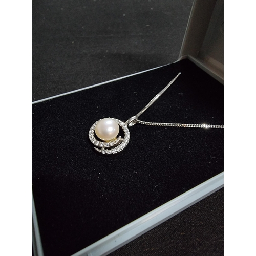 223 - 925 silver pendant inset with a genuine pearl and a large quantity of cz stones with a swirl design ... 