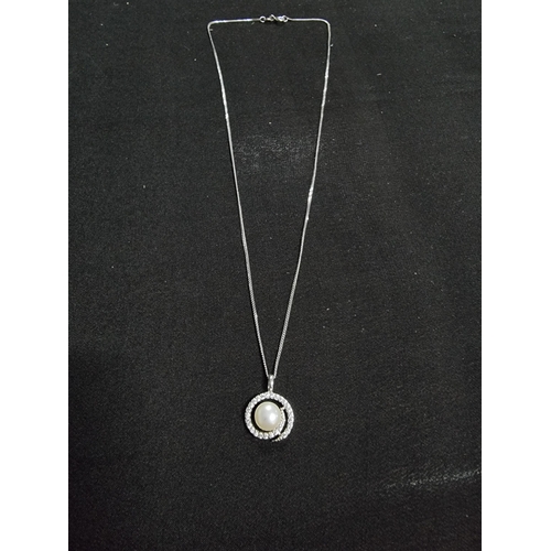 223 - 925 silver pendant inset with a genuine pearl and a large quantity of cz stones with a swirl design ... 