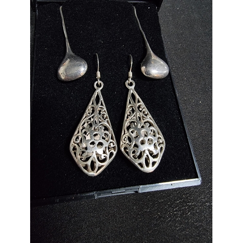 228 - 2 pairs of large 925 drop earrings one with an ornate pierced design the other has plain silver drop... 