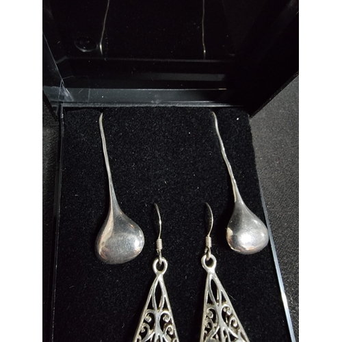 228 - 2 pairs of large 925 drop earrings one with an ornate pierced design the other has plain silver drop... 