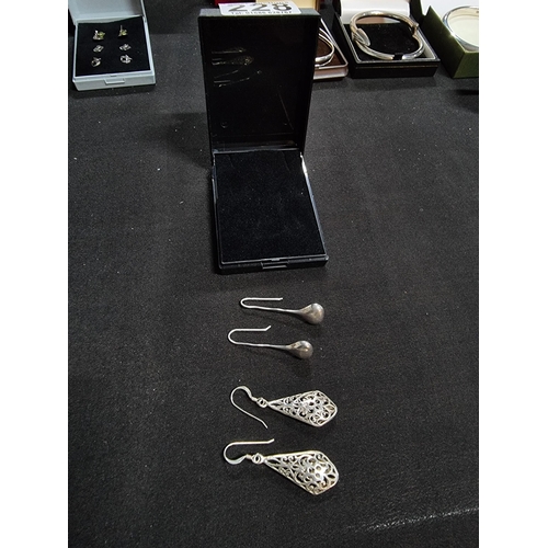 228 - 2 pairs of large 925 drop earrings one with an ornate pierced design the other has plain silver drop... 