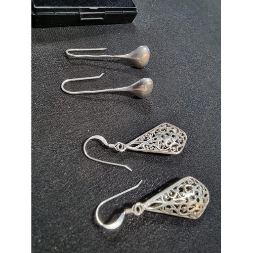 228 - 2 pairs of large 925 drop earrings one with an ornate pierced design the other has plain silver drop... 