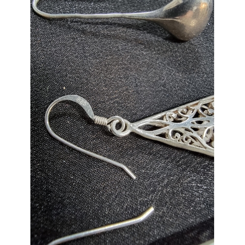 228 - 2 pairs of large 925 drop earrings one with an ornate pierced design the other has plain silver drop... 