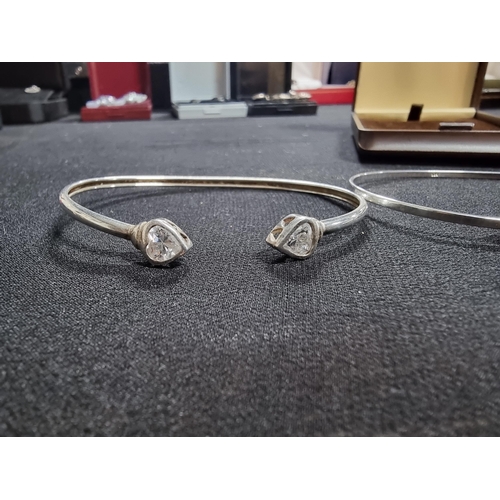 229 - 2 x 925 silver bangles one with cz stone heart formed ends the other with ball ends both in excellen... 