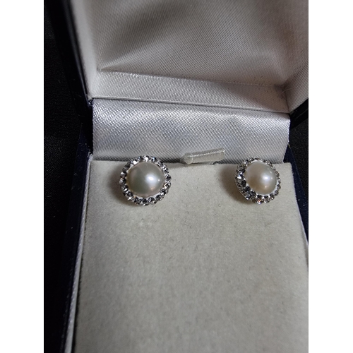 235 - Pair of new old stock 925 silver earrings inset with genuine pearls and cz stones