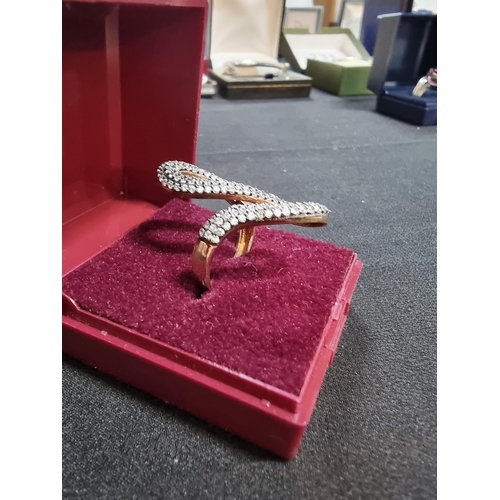 243 - Gold on 925 silver ornate snake ring inset with a large quantity of cz stones marked 925 in good con... 